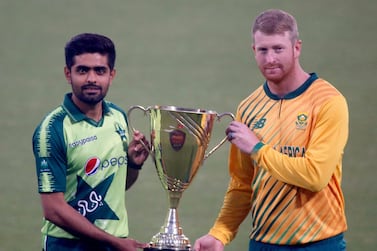 Pakistan's Twenty20 team's skipper Babar Azam, left, and his South Africa's counterpart Heinrich Klaasen, pose for photographer with trophy of Twenty20 series at the Gaddafi Stadium, in Lahore, Pakistan, Wednesday, Feb. 10, 2021. Pakistan and South Africa will play three Twenty20 match series, starting from Feb. 11. (AP Photo/K.M. Chaudary)