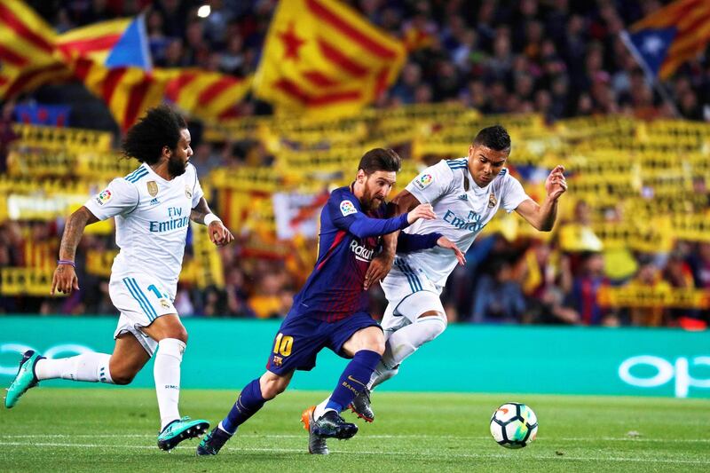 Barcelona's Lionel Messi in action against Real Madrid's Casemiro and Marcelo. Alejandro Garcia / EPA