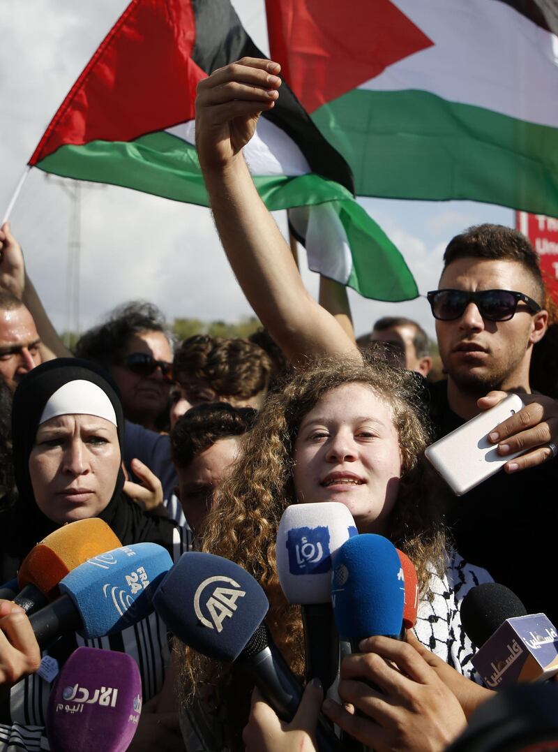 Ahed Tamimi was surrounded by reporters as she arrives at the West Bank village of Nabi Saleh, upon her release. AFP