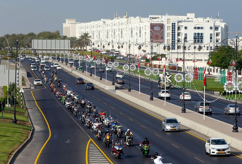 Bikers drive on a street in the Omani capital Muscat, on November 14, 2020, as part of the 50th National Day celebrations. AFP