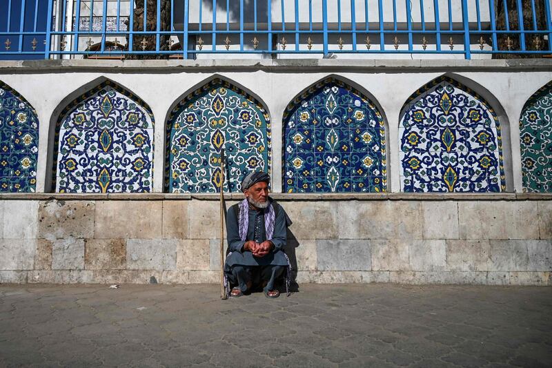 A man sits outside the Pul-e Khishti mosque at the start of the Eid Al Fitr festival in Kabul on May 24, 2020. AFP