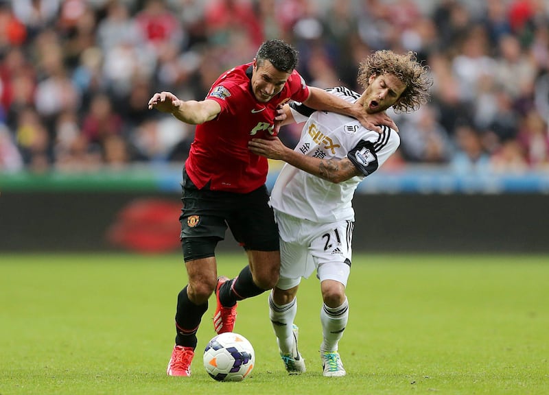 Manchester United's Robin van Persie, left, and Swansea City's Jose Alberto Canas battle for the ball during the English Premier League soccer match at the Liberty Stadium, Swansea, England, Saturday August 17, 2013. (AP Photo/Nick Potts, PA) UNITED KINGDOM OUT - NO SALES - NO ARCHIVES *** Local Caption ***  Britain Soccer Premier League.JPEG-0a5d9.jpg