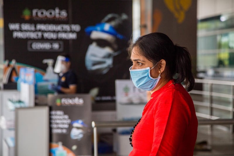 DELHI, INDIA - MAY 26: An Indian taveller wearing a protective mask waits at the drop-off point of Terminal 3 of the Indira Gandhi International Airport, as the country relaxed its lockdown restriction on May 26, 2020 in Delhi, India. With a slew of guidelines for passengers, India allowed commercial domestic flights to resume operations on May 25 for the first time since imposing a nationwide lockdown on March 25 to curb the spread of coronavirus, which has reportedly claimed around 4,000 lives in India so far.  (Photo by Yawar Nazir/Getty Images)