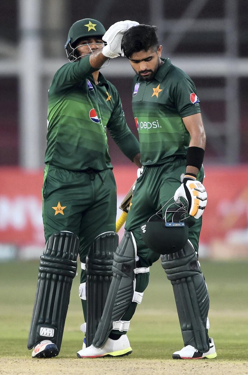 Pakistan's captain Sarfraz Ahmed (L) congratulates to teammate Babar Azam after score a century (100 runs) on the second one day international (ODI) cricket match between Pakistan and Sri Lanka at the National Cricket Stadium in Karachi on September 30, 2019. (Photo by ASIF HASSAN / AFP)