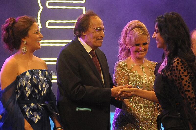 Egyptian actress Hanan Mutawe shakes hands with veteran Egyptian actor Ezzat el-Alayli while film stars Yusra (2nd R) and Nermin al-Feqi (L) look on during the opening ceremony of the 32nd Alexandria film festival in Egypt's northern coastal city of Alexandria on September 21, 2016. (Photo by STRINGER / AFP)