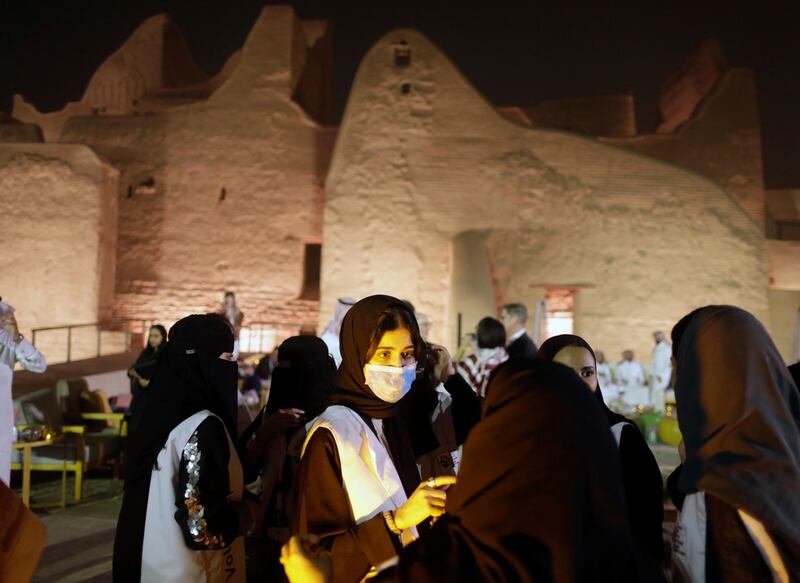 A tour guide wears a mask, due to the coronavirus, in front of the historical Salwa Palace, in Diriyah, outside Riyadh, Saudi Arabia. AP