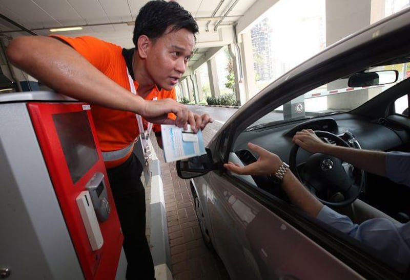 John Alagao, a parking attendant at the Mall of the Emirates, explains the new parking system.