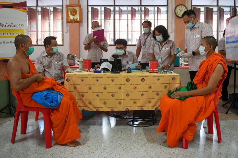 Buddhist monks wait to receive a dose of China's Sinovac coronavirus disease (COVID-19) vaccine at a temple in Bangkok, Thailand. REUTERS