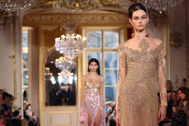 A muted gold dress with a scooped neckline and beaded 'jewellery'. AFP
