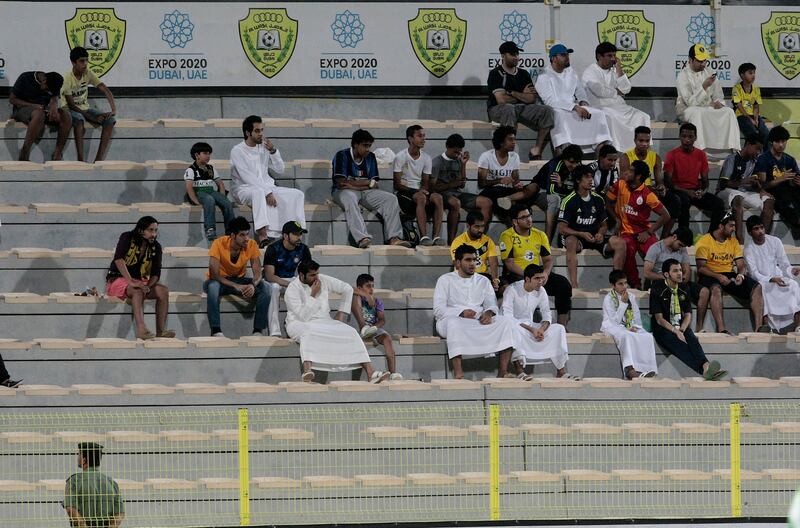Dubai, United Arab Emirates - April 14, 2013.  Some spectators watches the ongoing match between Dibba Al Fujairah and Al Wasl at the Etisalat Pro League round 21.  ( Jeffrey E Biteng / The National )