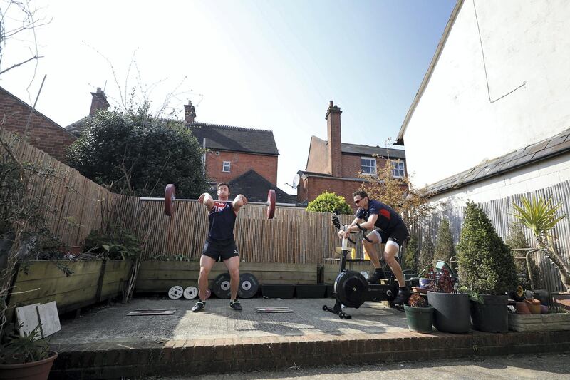 HENLEY-ON-THAMES - MARCH 27: Morgan Bolding (left) and Josh Bugajski (right) housemates and members of the Great Britain Rowing Team train together in their garden on March 27, 2020 in Henley-on-Thames, England. The coronavirus and the disease it causes, COVID-19, are having a fundamental impact on society, government, sports and the economy in United Kingdom. As all sports events in United Kingdom have been cancelled athletes struggle to continue their training as usual. (Photo by Naomi Baker/Getty Images)