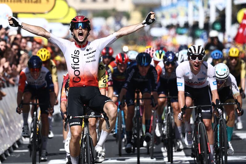 Cofidis' French rider Victor Lafay celebrates as he cycles to the finish line to win ahead of UAE Team Emirates' Slovenian rider Tadej Pogacar wearing the best young rider's white jersey (R) the 2nd stage of the 110th edition of the Tour de France cycling race 208,9 km between Vitoria-Gasteiz and San Sebastian, in northern Spain, on July 2, 2023.  (Photo by Anne-Christine POUJOULAT  /  AFP)