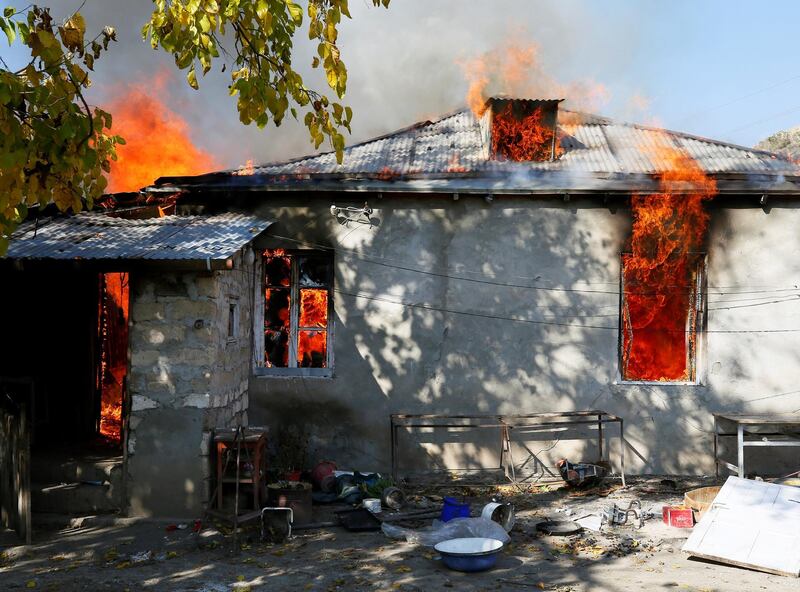 A house is seen set on fire by departing Ethnic Armenians, in an area which in the village of Cherektar in the region of Nagorno-Karabakh.  Reuters