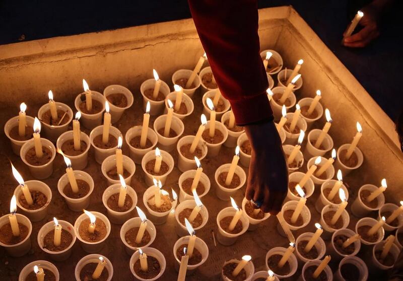 Afghan members of civil society organizations light candles during a memorial service for the victims of the landslide at Aab Bareek village, Bamiyan province, Afghanistan.  Kamran Shefayee / AFP