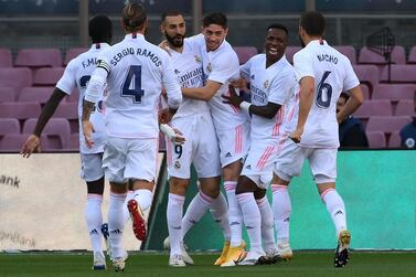 TOPSHOT - Real Madrid's players celebrate after scoring a goal during the Spanish League football match between Barcelona and Real Madrid at the Camp Nou stadium in Barcelona on October 24, 2020. / AFP / LLUIS GENE