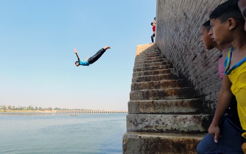 An Egyptian teen jumps into the water of the Nile on the outskirts of Cairo. EPA