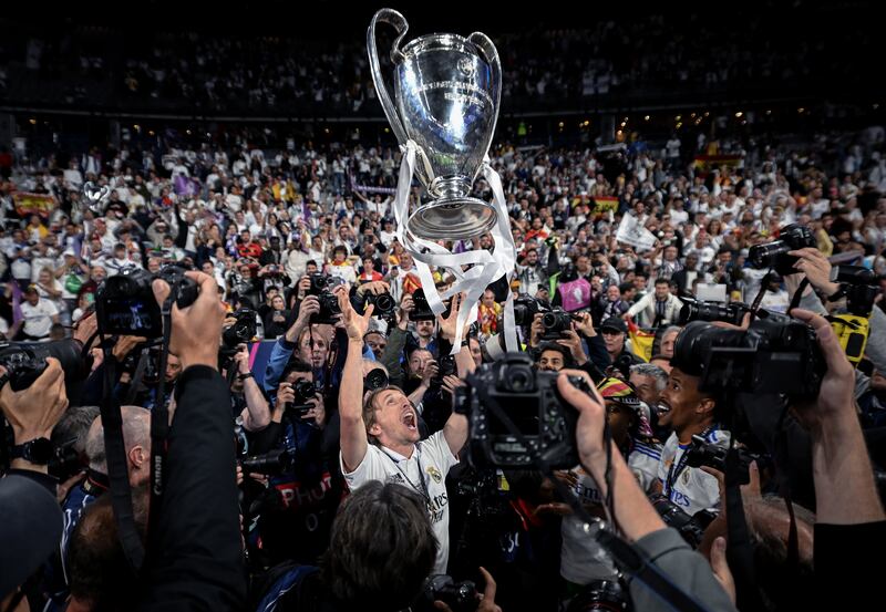 Luka Modric of Real Madrid lifts the trophy in front of fans  after the Champions League final against Liverpool in Paris on May 28. Getty Images