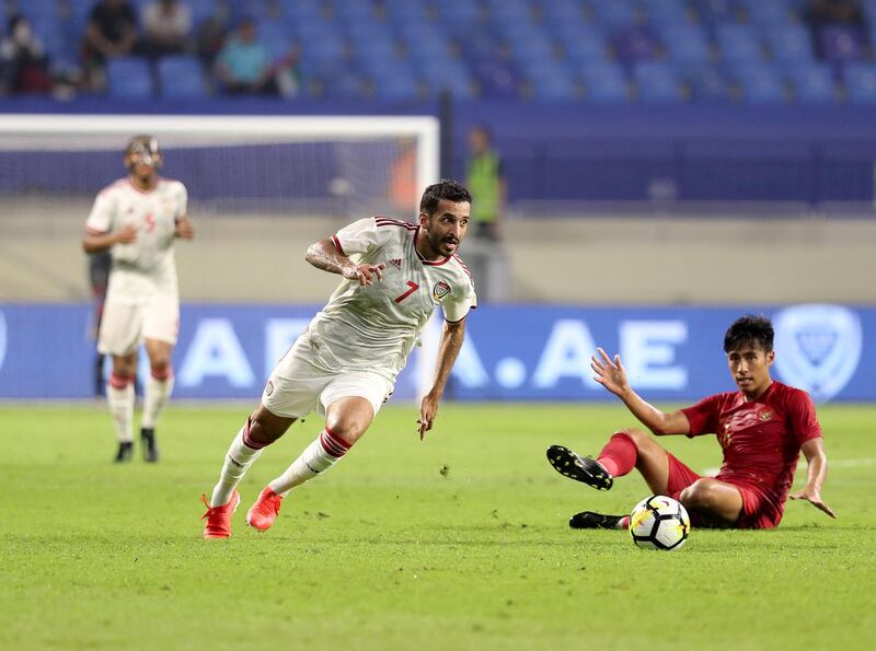 Dubai, United Arab Emirates - October 10, 2019: Ali Mabkhout of the UAE and Hanif Abdurrauf Sjahbandi of Indonesia during the Qatar 2022 world cup qualifier between The UAE and Indonesia. Thursday 10th of October. Al Maktoum Stadium, Dubai. Chris Whiteoak / The National