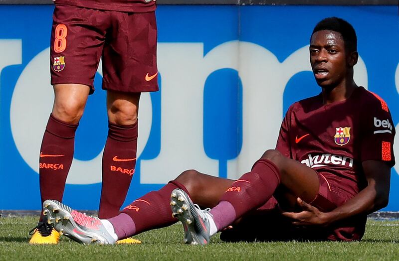 Barcelona's record signing Ousmane Dembele reacts after sustaining an injured during his Spanish La Liga match against Getafe at Colisseum Alfonso Perez stadium in Getafe, Spain, September 16, 2017. Picture taken September 16, 2017. REUTERS/Paul Hanna