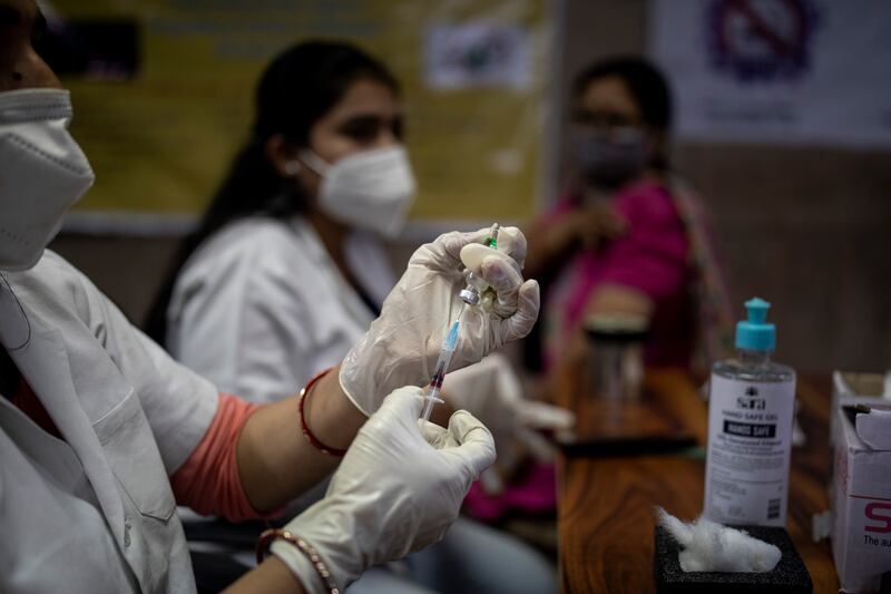 A health worker prepares to administer the Covishield vaccine at a hospital in New Delhi, India.