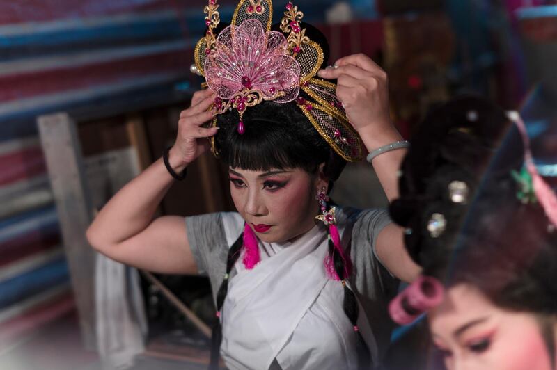 A Chiu Chow opera performer gets ready for the show backstage. EPA