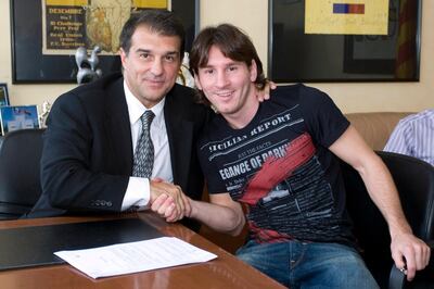 This handout picture released by the FC Barcelona on September 20, 2009 shows Barcelona's club President Joan Laporta (L) posing with Argentine Lionel Messi on September 18, 2009 in Barcelona, after Messi signed a new two-year deal with Barcelona, which will keep him at the club until 2016. A buy-out clause for Messi, 22, has also risen from 150 million to an even more staggering 250 million euros. AFP PHOTO / HANDOUT FC BARCELONA - RETRICTED TO EDITORIAL USE- (Photo by HO / FC BARCELONA / AFP)