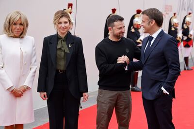 Ukrainian President Volodymyr Zelenskyy will use the Swiss talks to pitch a peace formula to leaders including France's Emmanuel Macron, right. They are pictured with France's first lady Brigitte Macron, left, and Ukraine's first lady Olena Zelenska. AP 