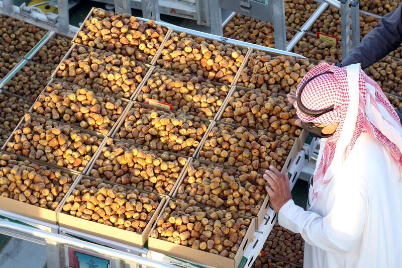 A Saudi farmer displays dates to customers during Unaizah Season for Dates, at Unaizah city in Al-Qassim province, Saudi Arabia. Reuters