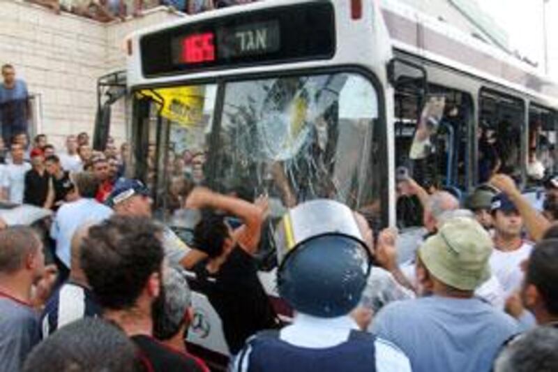 Angry people attack a bus after a shooting in the Israeli Arab village of Shefa'amr in 2005.