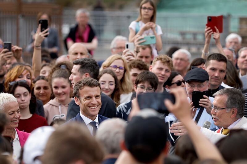 Mr Macron speaks to residents in Chatenois, Alsace. AP