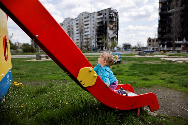 Nina Stefuryak, 2, playing in a park in front of a building destroyed by shelling in Borodianka, Kyiv region, Ukraine. Reuters