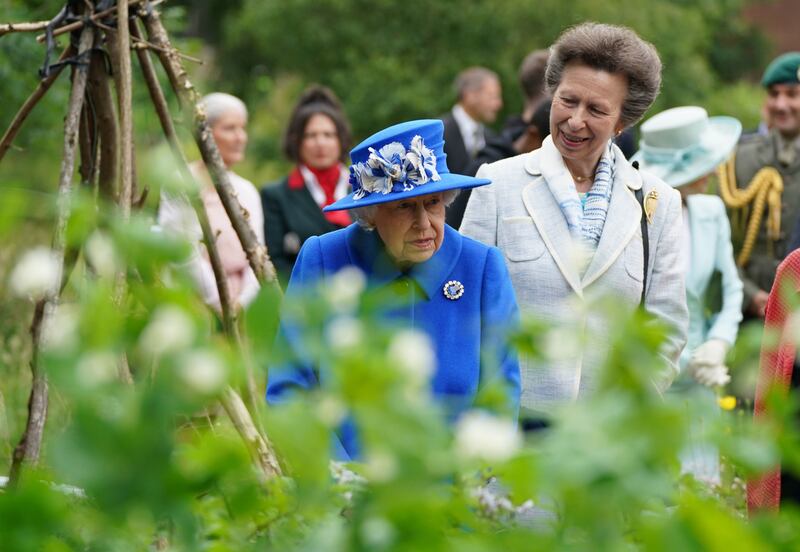 Queen Elizabeth and Princess Anne visit the Children's Wood Project, a community project in Glasgow, as part of her traditional trip to Scotland for Holyrood Week in 2021.