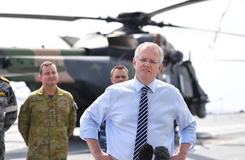 epa07176675 Australian Prime Minister Scott Morrison speaks to journalists on the Royal Australian Navy (RAN) Canberra class HMAS Adelaide (L01) helicopter landing dock ship after the 2018 Asia-Pacific Economic Cooperation (APEC) forum in Port Moresby, Papua New Guinea, 19 November 2018.  EPA/MICK TSIKAS  AUSTRALIA AND NEW ZEALAND OUT