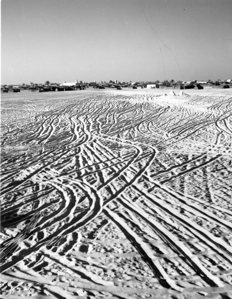 Abu Dhabi, Trucial States; Undated (late 1950 s, early 1960 s)  shot of tyre tracks in the sand. The view shows Abu Dhabi town from the house of the Hillyard family, early British expats working in the oil industry. 

Courtesy BP Archive. Mandatory Credit. 
Eds note. Karen  ** Free usage but  email BP Abu Dhabi to notify of publication** Nick.Cochrane-Dyet@se1.bp.com