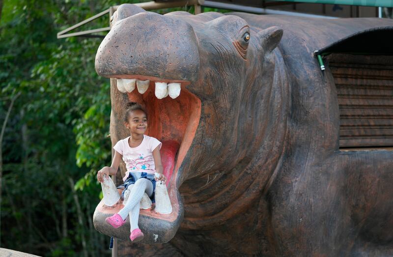 A child on a statue of a hippo at the entrance of Hacienda Napoles, that was once the private zoo with illegally imported hippos and other animals that belonged to the late drug lord Pablo Escobar, in Puerto Triunfo, Colombia, on February 15. Colombia's Environment Ministry announced hippos are an invasive species, whose growing numbers pose a threat to biodiversity. AP