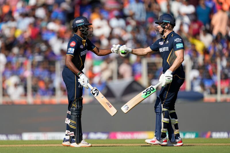 Gujarat Titans' Sai Sudharsan, left, is congratulated by teammate David Miller after reaching his fifty. He made 84 not out off 49 balls, while Miller was not out on 26 off 19. AP 