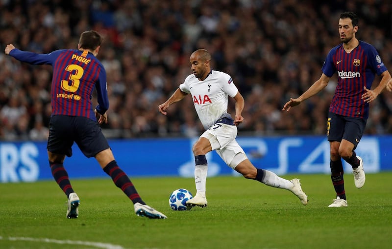 Tottenham Hotspur's Lucas Moura takes on Barcelona's Sergio Busquets and Gerard Pique. AFP