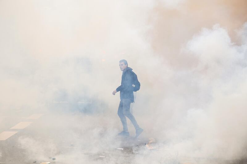 A lone protester emerges from clouds of smoke. Jeff J Mitchell/Getty Images