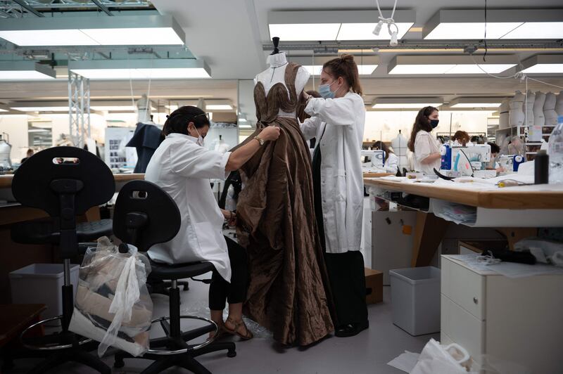 Employees works on the haute couture collection at the Christian Dior headquarters in Paris on July 3, 2021.