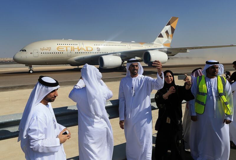 ABU DHABI - UNITED ARAB EMIRATES - 23DEC2014 - Abu Dhabi Airport officials photograph and take selfies as the Etihad Airbus 380 taxing towards the new South Runway to take-Off after announcing its opening yesterday at Abu Dhabi International Airport. Ravindranath K / The National (to go with Shereen  story for Business) *** Local Caption ***  RK2312-AIRPORT32.jpg