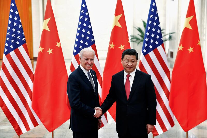 Chinese President Xi Jinping shakes hands with President Joe Biden inside the Great Hall of the People in Beijing. Reuters