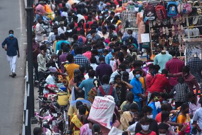People shop at the crowded Ranganathan street in Chennai this month. India's population growth has slowed in recent decades. EPA