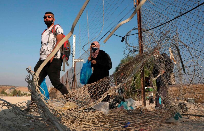 Palestinians enter illegally from a breach in a barrier fence into Israeli territory from the village of Al Dahriya, south the occupied West Bank town of Hebron. AFP