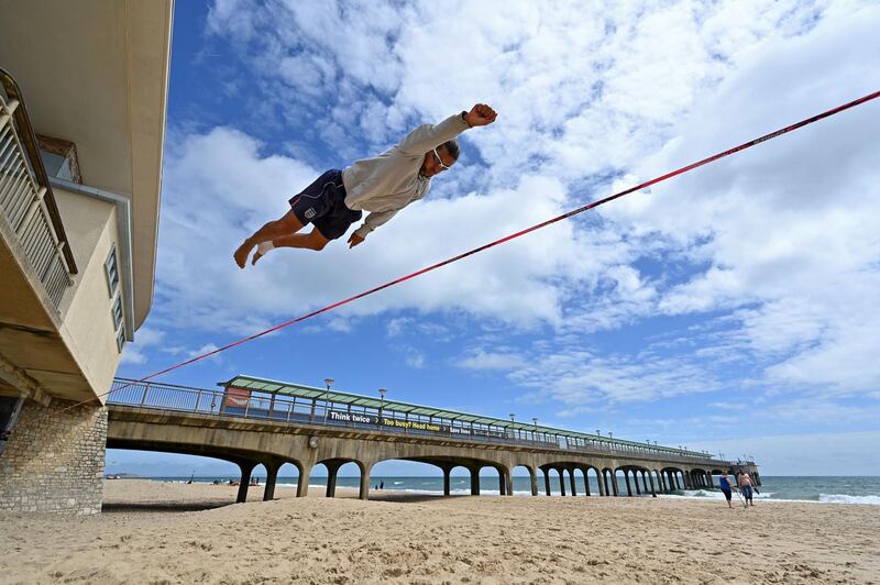 Slackliner Sandor Nagy practices on the beach in Boscombe, on the south coast of England.  AFP