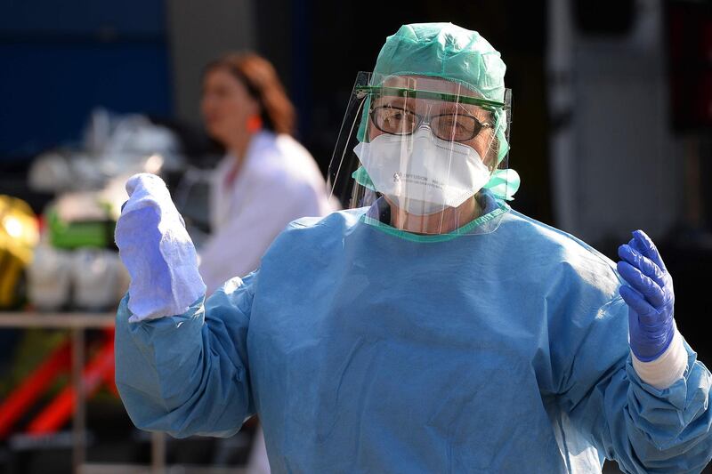 A nurse anesthetist gestures during the disinfection of ambulances, in Brest, western France.   AFP