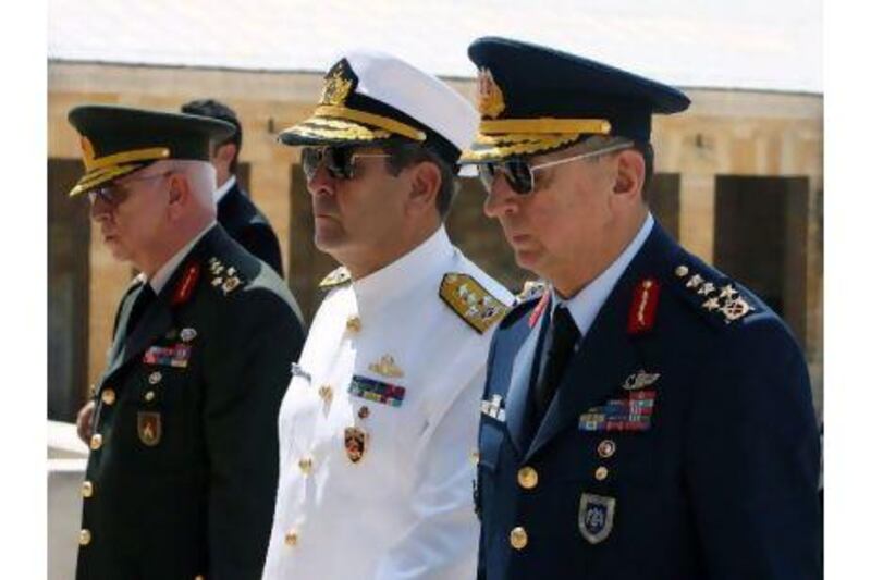 The Turkish chief of staff, General Isik Kosaner, left, the navy commander, Admiral Esref Ugur Yigit, centre, and the air force commander, General Hasan Aksay. General Kosaner and the commanders of the navy, the army and the air force suddenly resigned last Friday. Burhan Ozbilici / AP Photo