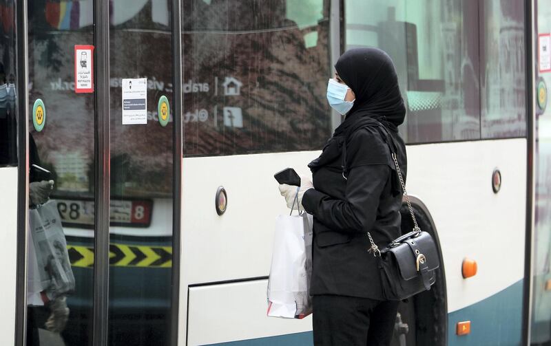 ABU DHABI, UNITED ARAB EMIRATES , June 1 – 2020 :- A woman wearing protective face mask as a preventive measure against the spread of coronavirus at the bus stop in Abu Dhabi. UAE government lifts the coronavirus restriction for the residents and businesses around the country. (Pawan Singh / The National) For News/Stock