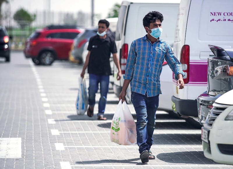 Abu Dhabi, United Arab Emirates, April 5, 2020.  Grocery shoppers with face mask s on at Souk Planet, Khalifa City.  Face masks should be worn at all times when outside the home, the UAE government said on Saturday.      Victor Besa / The National