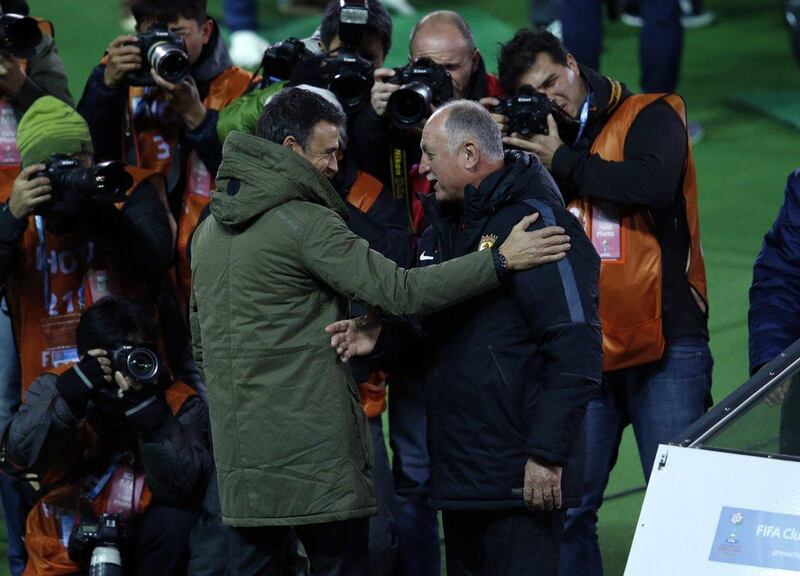 Barcelona coach Luis Enrique, left, talks with Guangzhou Evergrande coach Luiz Felipe Scolari. Yuya Shino / Reuters