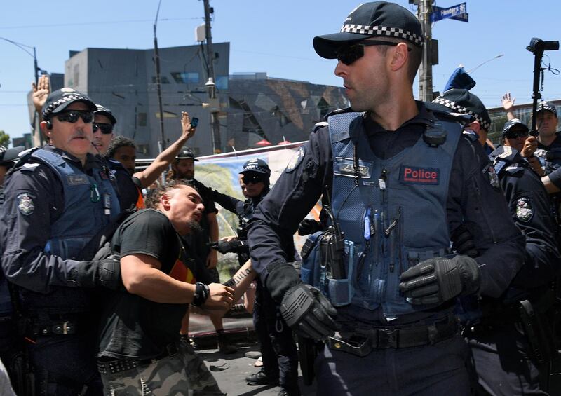 Police officers intervene after a fight broke out between Invasion Day protesters and two far right activists.  EPA